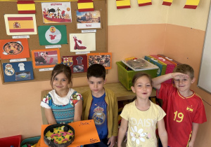 dzieci pozują do zdjęcia ze swoją pracą