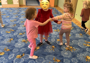 trzy dziewczynki tańczą w kółeczku