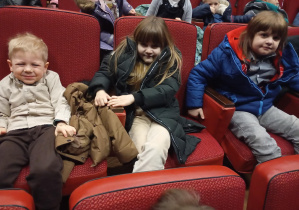 dzieci siedzą na widowni w teatrze