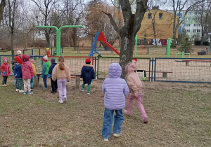 dzieci sprzątają okolice placu zabaw