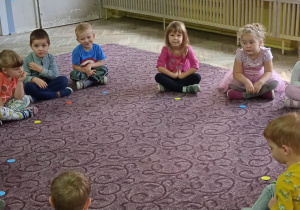 Dzieci siedzą razem na dywanie