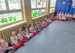 Cała grupa siedzi wspólnie w dużej sali przedszkolnej