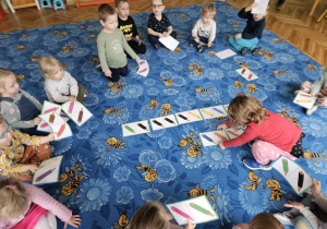 dzieci układają duże domino z obrazkami kredek