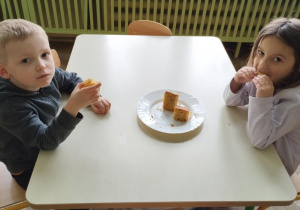 Chłopiec i dziewczynka jedzą ciasto
